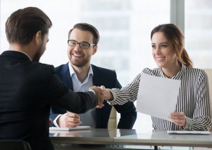 Happy employers shake hand of male job candidate, congratulating with given position, satisfied HR managers happy to hire applicant handshake greeting at team. Successful good interview concept
